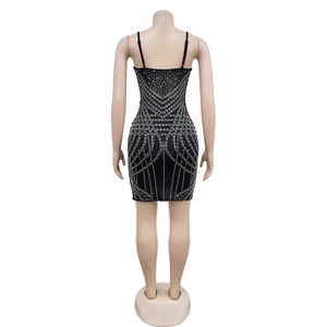 Close-up of black bodycon mini dress with intricate rhinestone geometric patterns