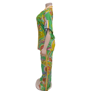 Detail view of stylish green pop-art print shirt with lapel collar and matching trousers