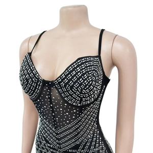 Detail of silver rhinestones and mesh fabric on a black bodycon party bodysuit