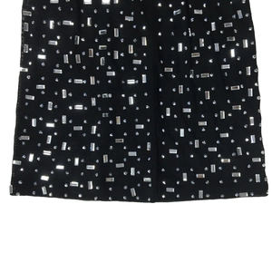 Detail of silver rhinestones and sequins on premium black mesh fabric garment