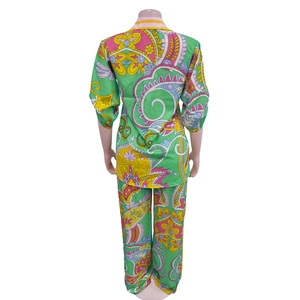 Rear view of vibrant paisley print two-piece set with long-sleeved shirt and trousers