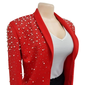 Detail view of red blazer lapel featuring intricate pearl and rhinestone embellishments