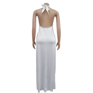 Detail of the back view showing a halter neck tie and open back white floor-length dress