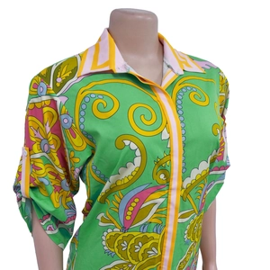 Detail of vibrant paisley and floral print on green long-sleeve bohemian style shirt