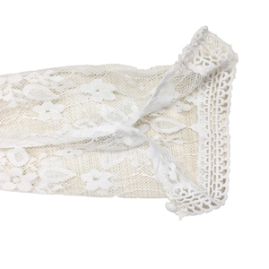 Detailed view of white floral lace cuff with decorative hollow crochet wavy edge