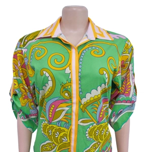 Detailed close-up of vibrant green floral print shirt with stylish striped piping accents