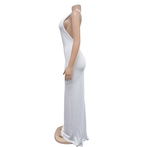 Detail view of white backless dress featuring side cut-outs and elegant pleated long skirt
