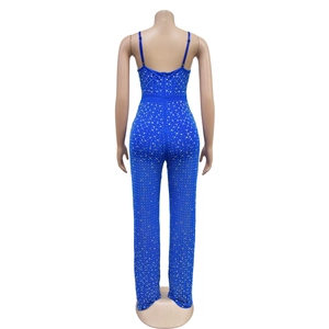 Detail view of the back of a blue rhinestone mesh jumpsuit with thin straps and a zipper