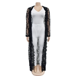Detailed close-up of intricate floral lace patterns on the long black sheer cardigan