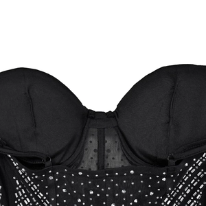 Close-up of black mesh bodice featuring sparkling rhinestones and polka dot fabric