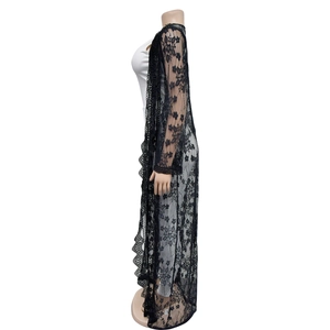 Detailed close-up of long black floral lace cardigan with semi-sheer fabric and crochet edges