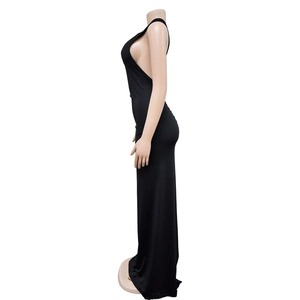 Detail of elegant black backless dress with side-boob cut and irregular hemline