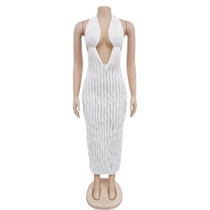 Close-up of white halter maxi dress with intricate vertical pleated texture and deep V-neck