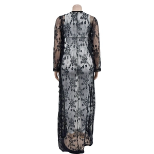 Back view of a long black lace cardigan with floral patterns and a floor-length silhouette