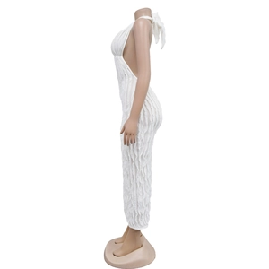 Detail showing the white halter neck dress with textured wavy fabric and open back design