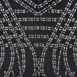Close-up of geometric silver rhinestone pattern on a black mesh party dress