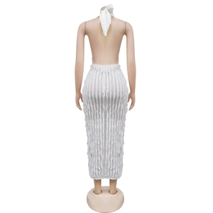 Detail of white halter backless dress featuring textured wave fabric and slim fit design