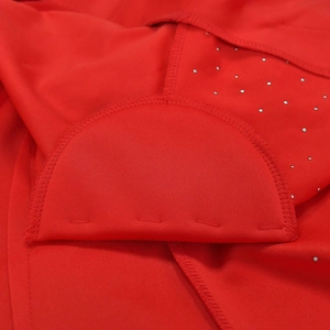 Close-up of bright red suit blazer fabric with silver rhinestones and interior stitching