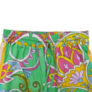 Detail view of colorful floral pattern trousers with elastic drawstring waist and soft fabric