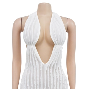 Detail of white deep V-neck halter dress featuring unique vertical pleated fabric texture