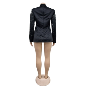 Detailed back view of a black satin blazer with elegant white pearl beads on sleeves