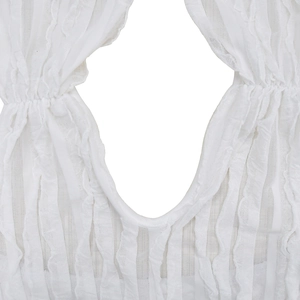 Close-up of white dress fabric with pleated texture and vertical wave hollow out design