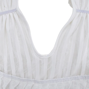 Detail of white hollow wavy long dress featuring gathered neckline and sheer texture
