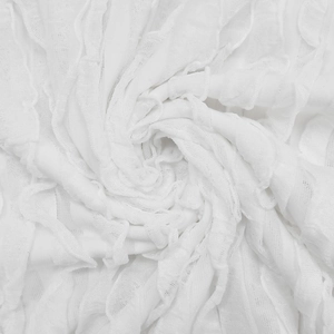 Detail of white hollowed wave pattern fabric with delicate pleated ruffles for dresses