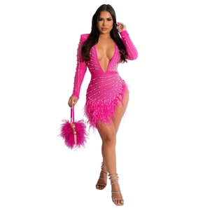 Pink sequin dress featuring feather trim cuffs and faux pearl embellishments details