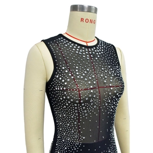 Detail of black mesh sleeveless top featuring silver square rhinestones and sequins