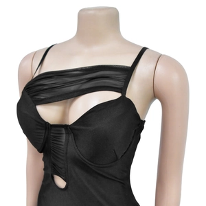 Close-up of black bandage dress featuring sheer mesh inserts and cutout details