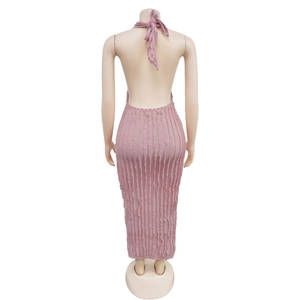Detail of pink halter neck dress featuring textured pleats and open back design