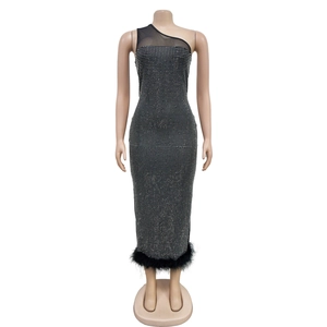 Detail of black one-shoulder bandage dress with silver rhinestones and feather hemline