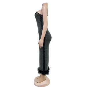 Detailed view of black bodycon maxi dress with silver rhinestones and feather hemline