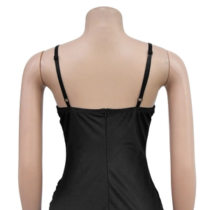 Detail view of the back of a black mesh dress with thin straps and hidden zipper