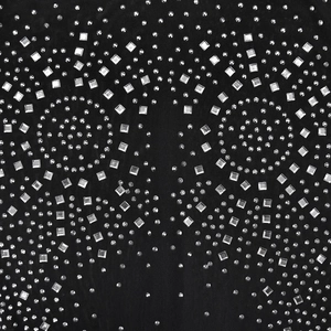 Macro view of black mesh fabric with sparkling silver rhinestones and geometric patterns