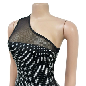 Detail of black one-shoulder dress with sparkling silver rhinestones and mesh patchwork