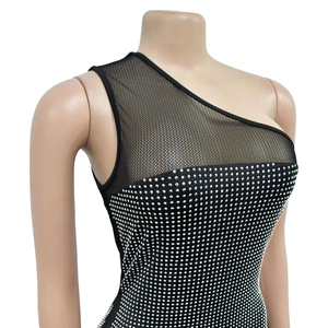 Detail of black one-shoulder dress featuring sheer mesh panel and dense silver rhinestones