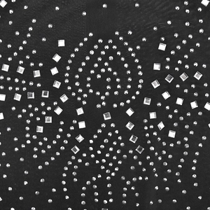 Detailed close-up of sparkling silver rhinestones on black mesh fabric of the long dress