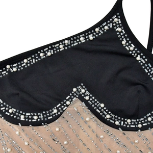 Détail du tissu en maille avec cristaux de strass et perles sur la robe élégante