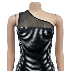 Detail of the one-shoulder black dress with mesh panel and sparkling silver rhinestones