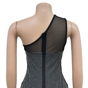Detail of black one-shoulder dress showing mesh splicing and silver rhinestone embellishments