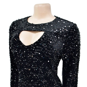 Close-up of black sequin long sleeve dress featuring heart-shaped neckline cutout