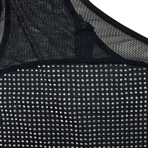 Detail of black mesh fabric with sparkling silver rhinestones on a bandage dress