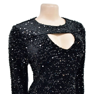Detail of black sequined mini dress with long sleeves and teardrop chest cutout detail