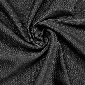 Macro shot of black metallic shimmer knit fabric with fine ribbed texture and soft drape