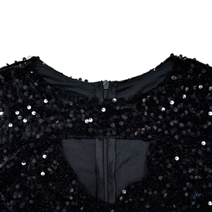 Detail of black sequined dress featuring a back invisible zipper and hollow triangular cutout