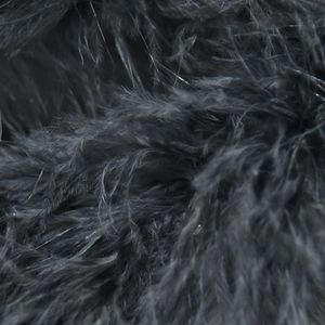 Close-up of black feather trim detail on dress with soft texture and rich plumes