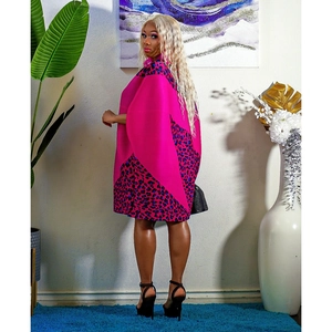 Detail of pink dress featuring flared cape sleeves and side leopard print contrast panels