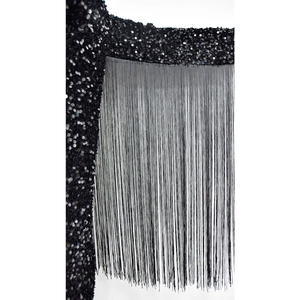 Detailed macro view of black sequins and long fringe tassels on modern mini dress